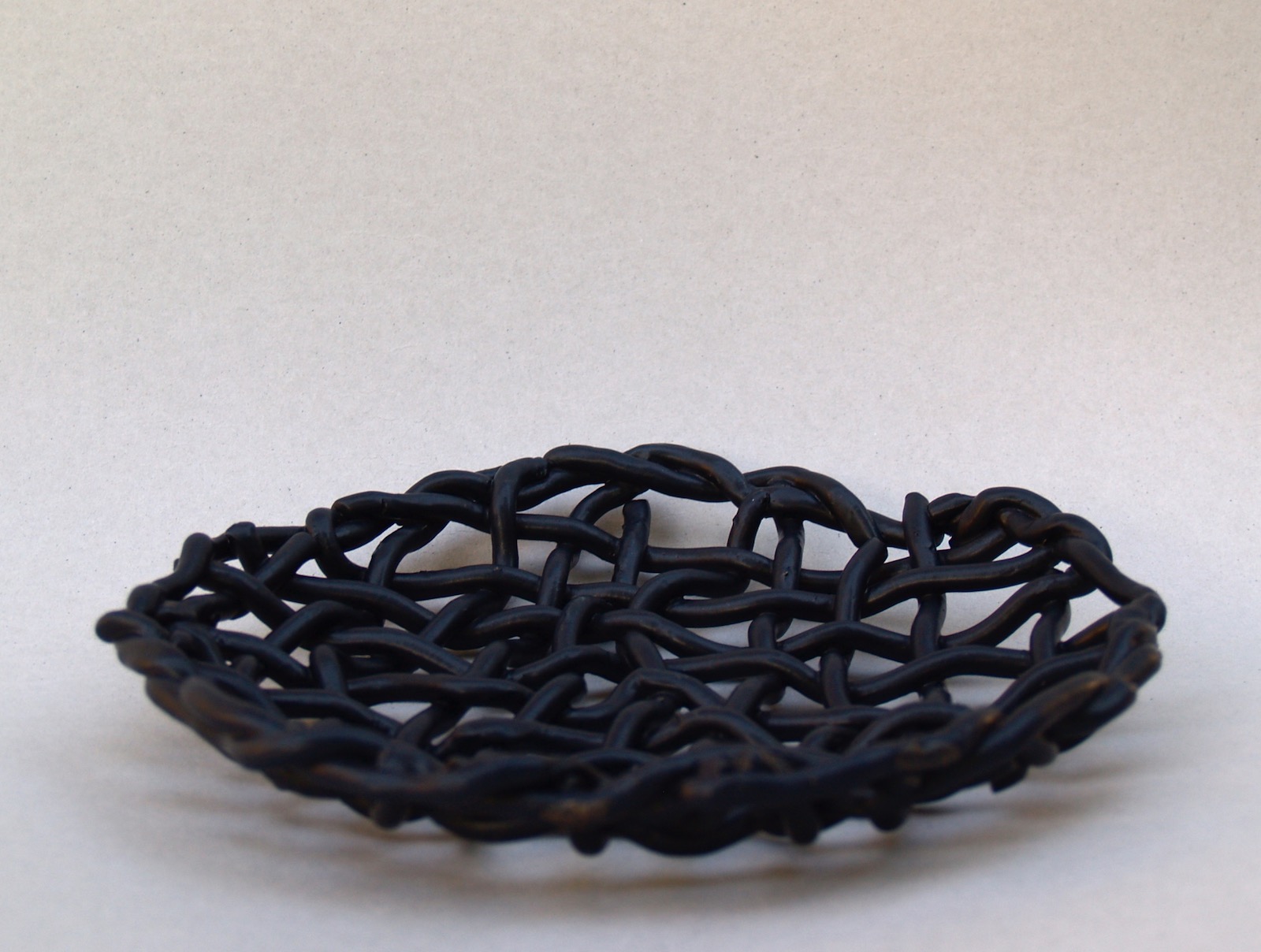Large dish of weaved black clay