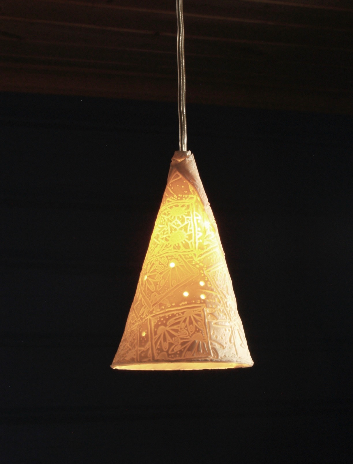 Cone shaped pendant light with abstract floral pattern