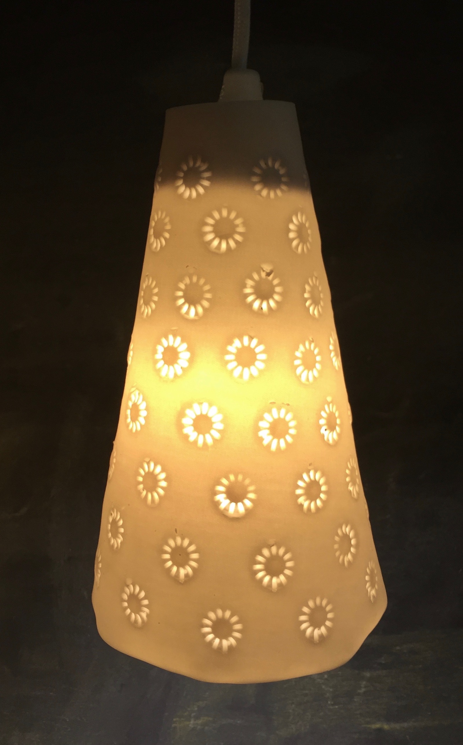 Cone shaped pendant light with daisy pattern