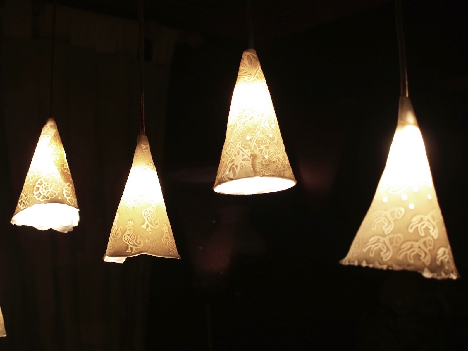 Group of four cone shaped pendant lights