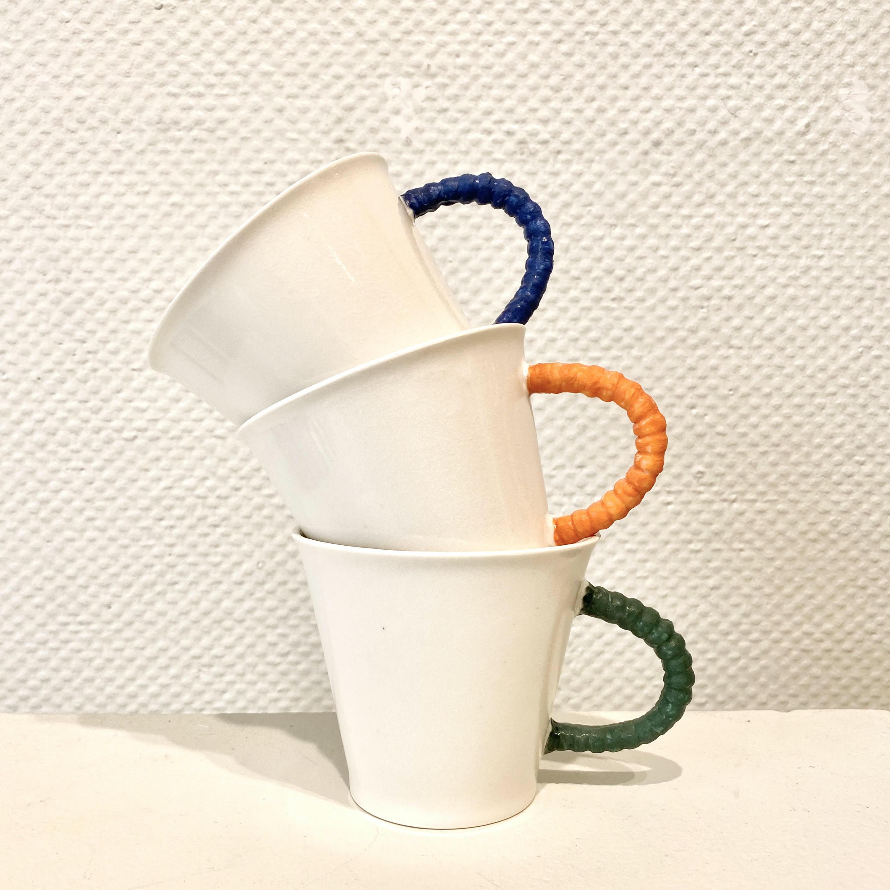 Porcelain mugs with handles in various colours