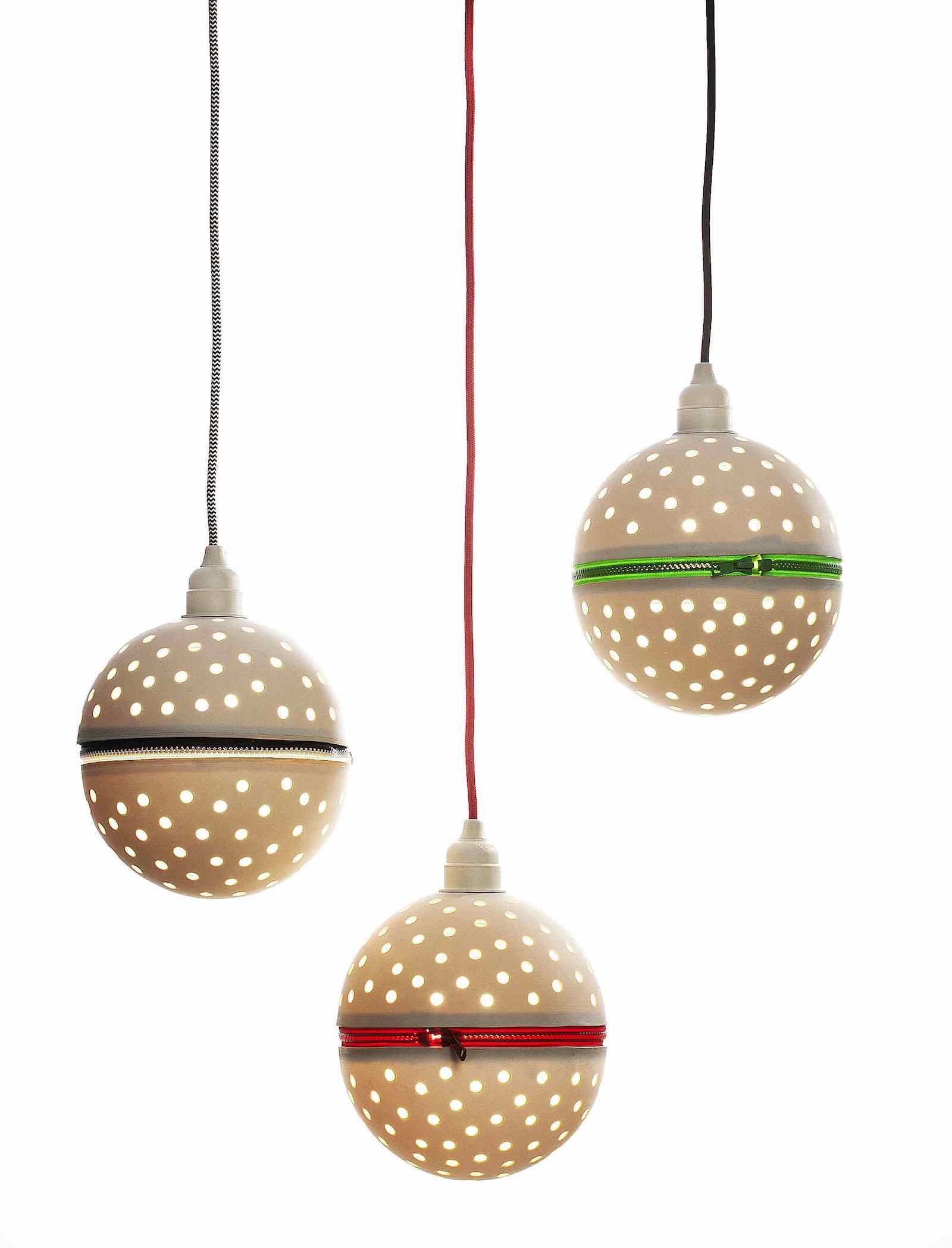 Group of three perforated porcelain globe pendants with colourful zips