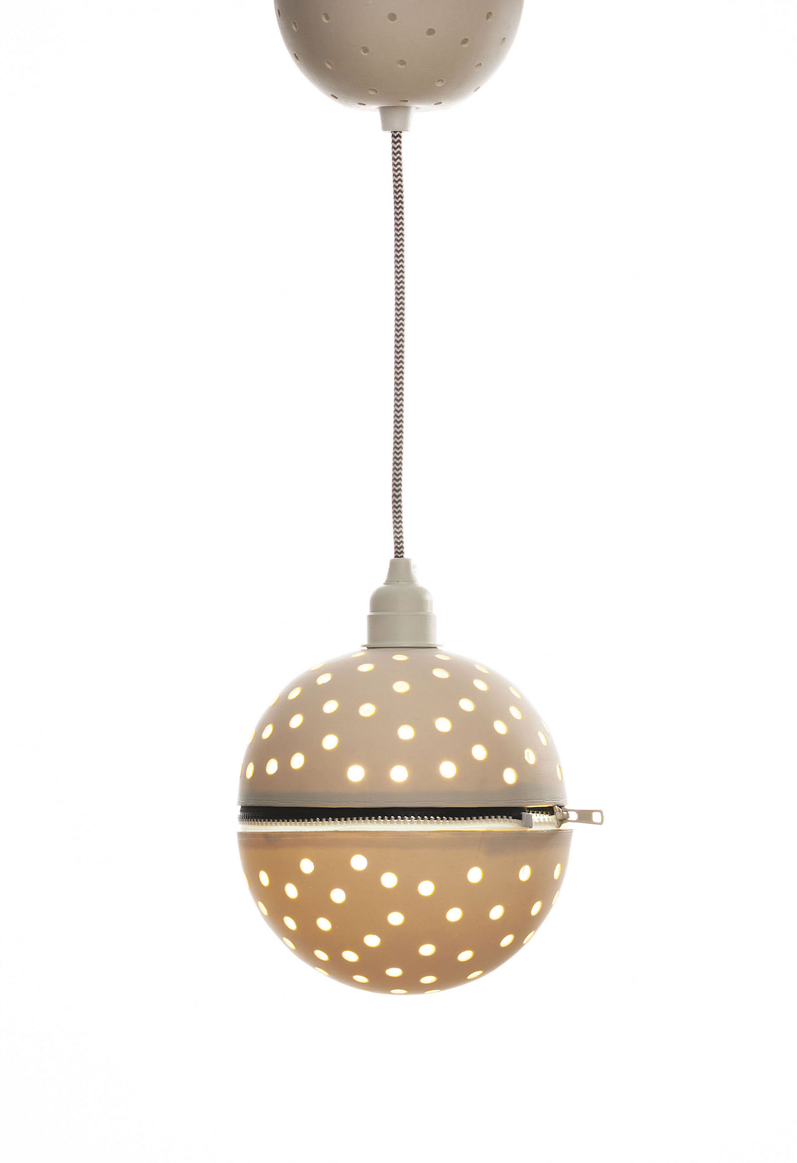 Perforated porcelain globe pendant with black and white zip