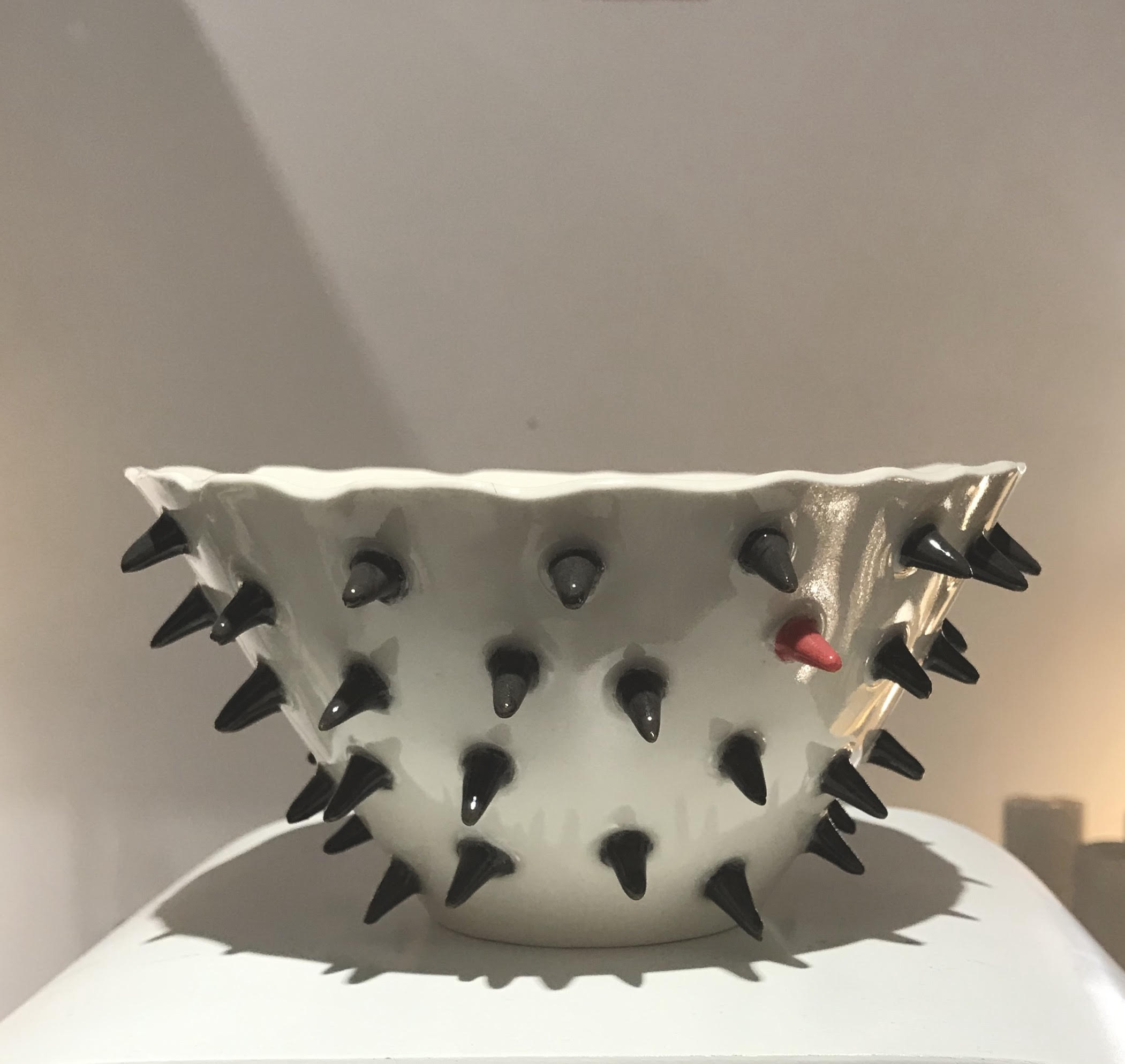 Small porcelain bowl with black spikes
